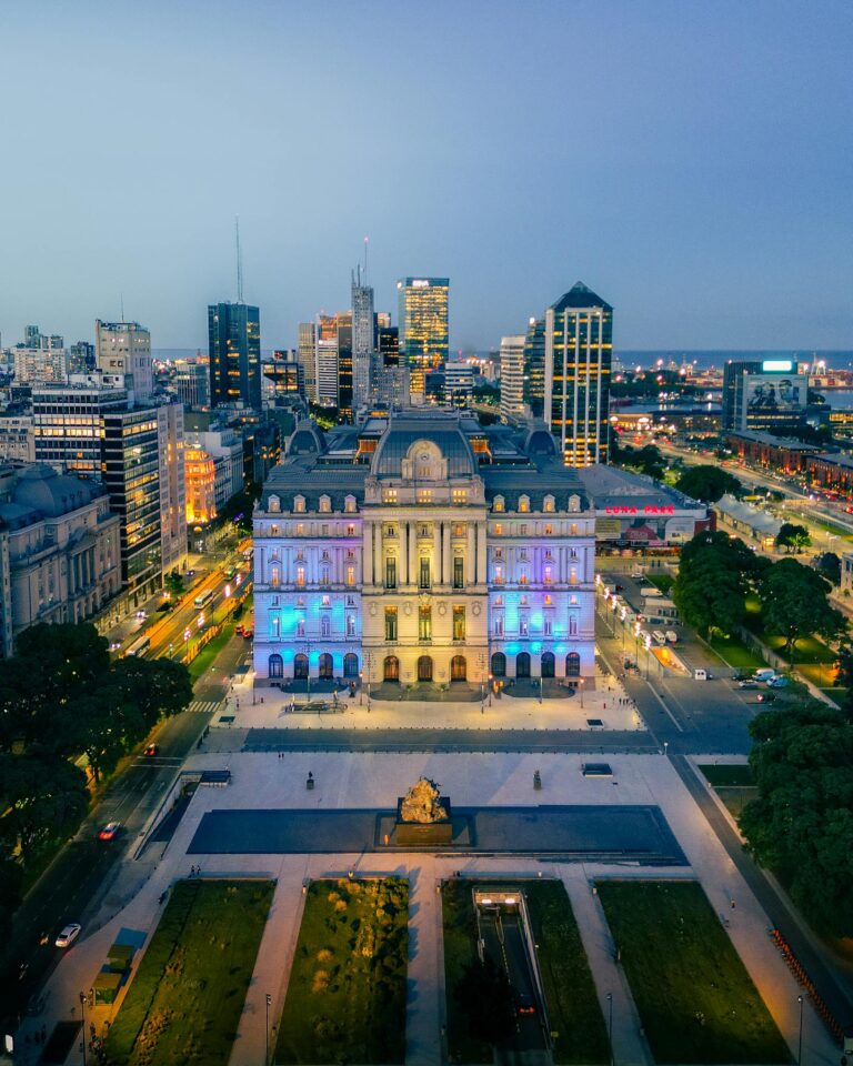 Stunning aerial view of Buenos Aires cityscape with illuminated palace at night.